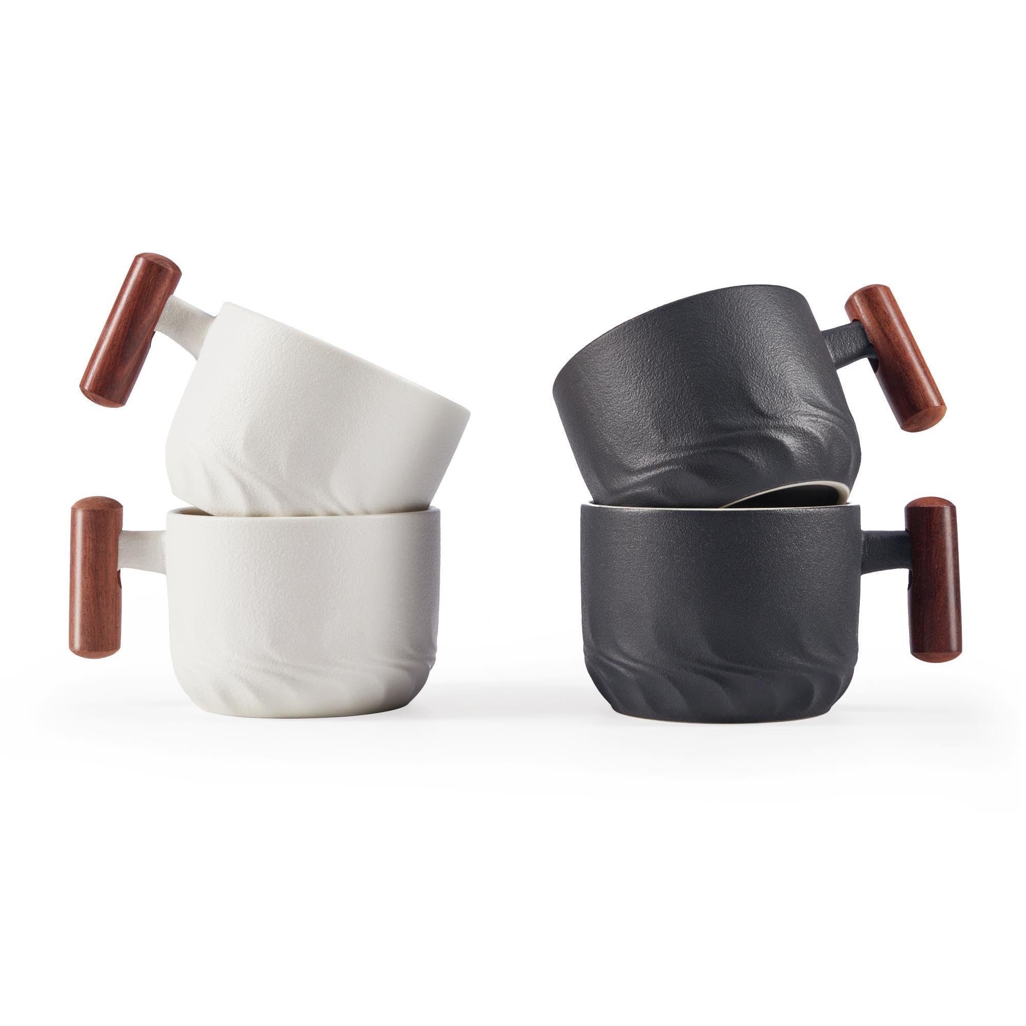 Set of ceramic cups with wooden handles on a white background