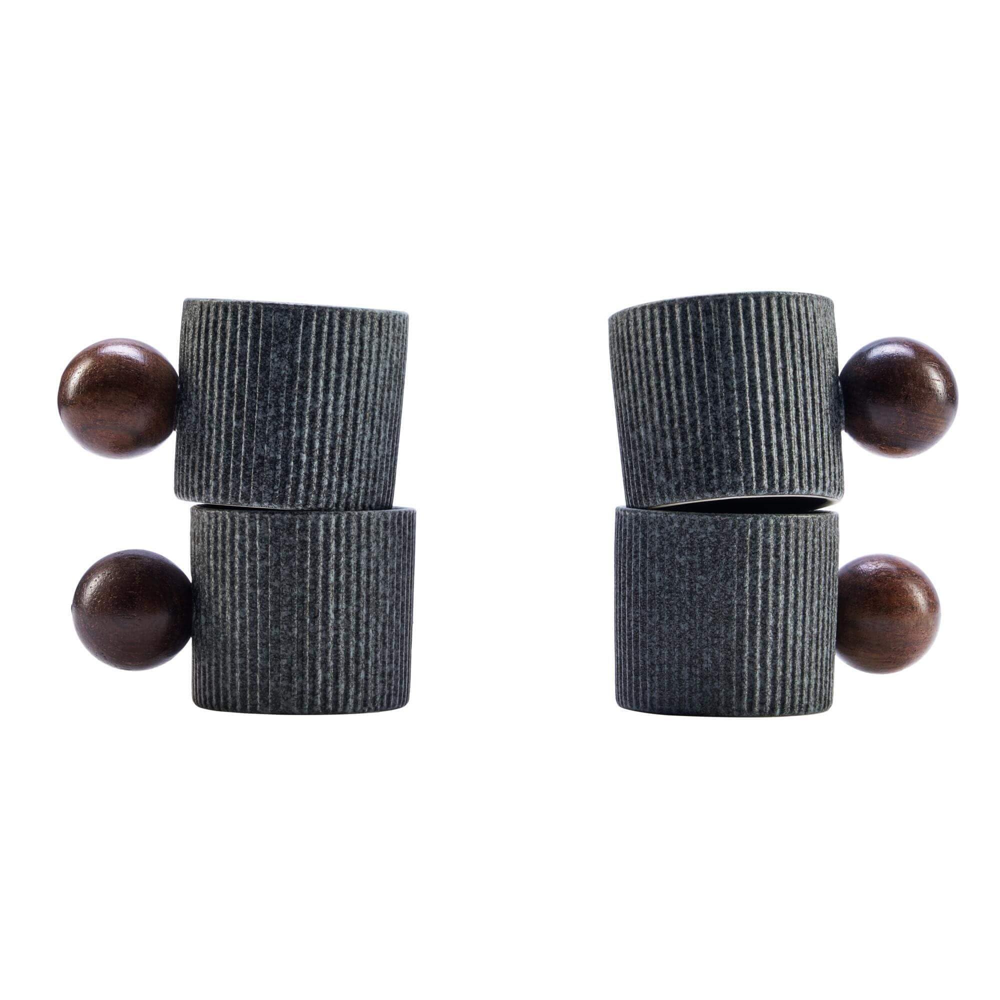 A pair of dark gray ribbed wooden peg earrings with round brown wooden beads, displayed on a clean white background.