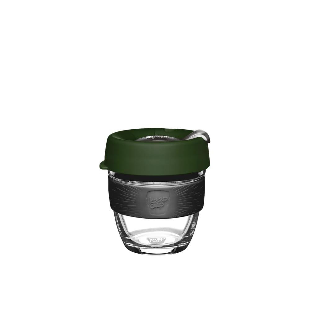 A reusable glass coffee cup with a dark green silicone lid, a black textured silicone sleeve, and a clear glass base, shown on a plain white background.