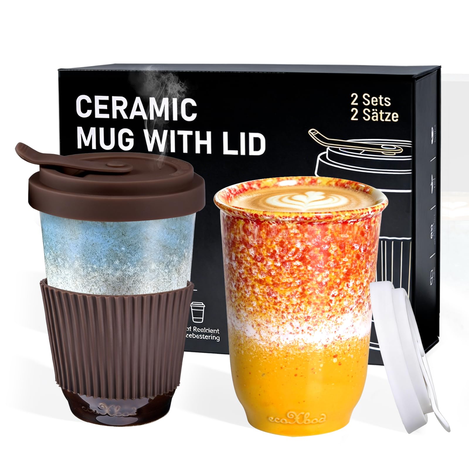 Two ecoChao reusable ceramic mugs with lids are shown in front of their black retail box. One mug has a brown silicone sleeve and a light blue gradient body; the other has a brown sleeve and an orange-to-yellow gradient body with latte art on top.