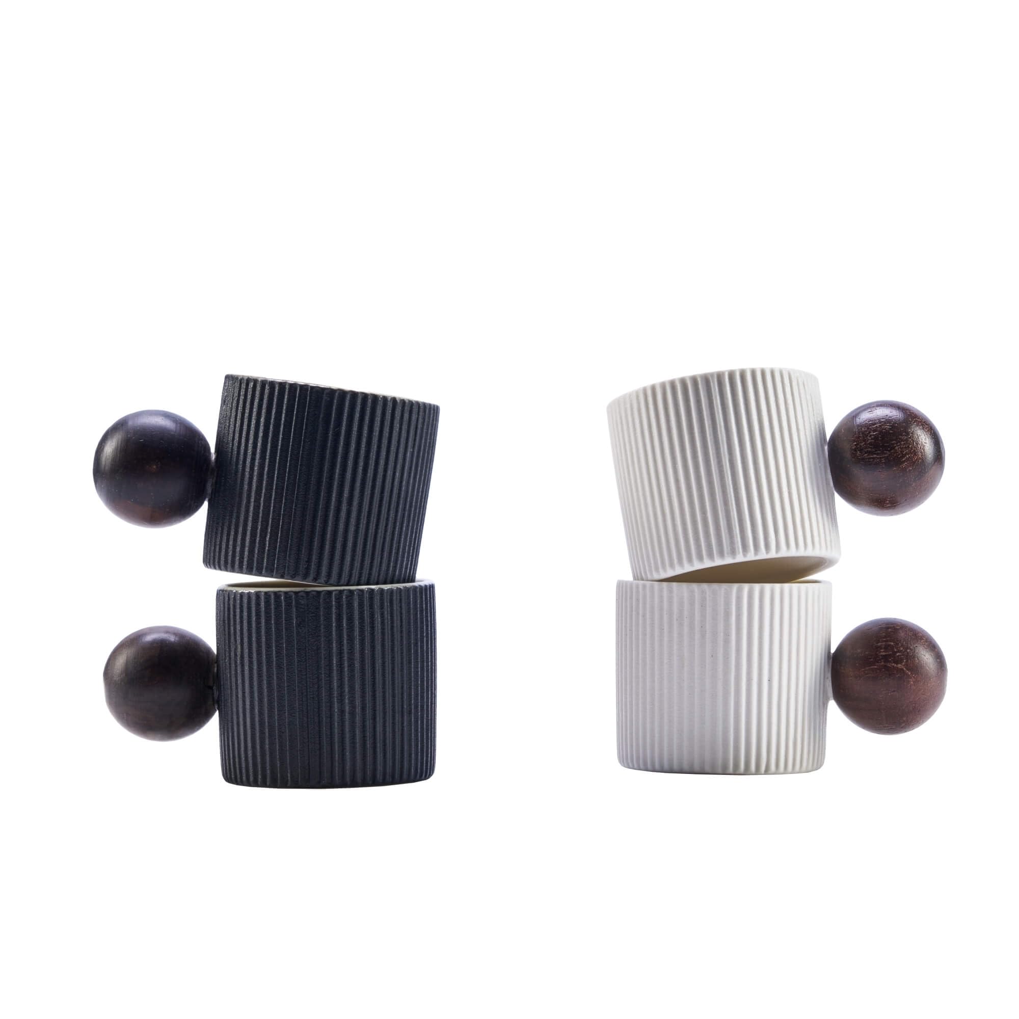 Two pairs of minimalist geometric earrings on a white background. Each earring features a ribbed cylindrical post with a spherical bead at the ends.
