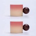 Two ribbed ceramic containers with a gradient color pattern and two wooden spheres on a light gray background.