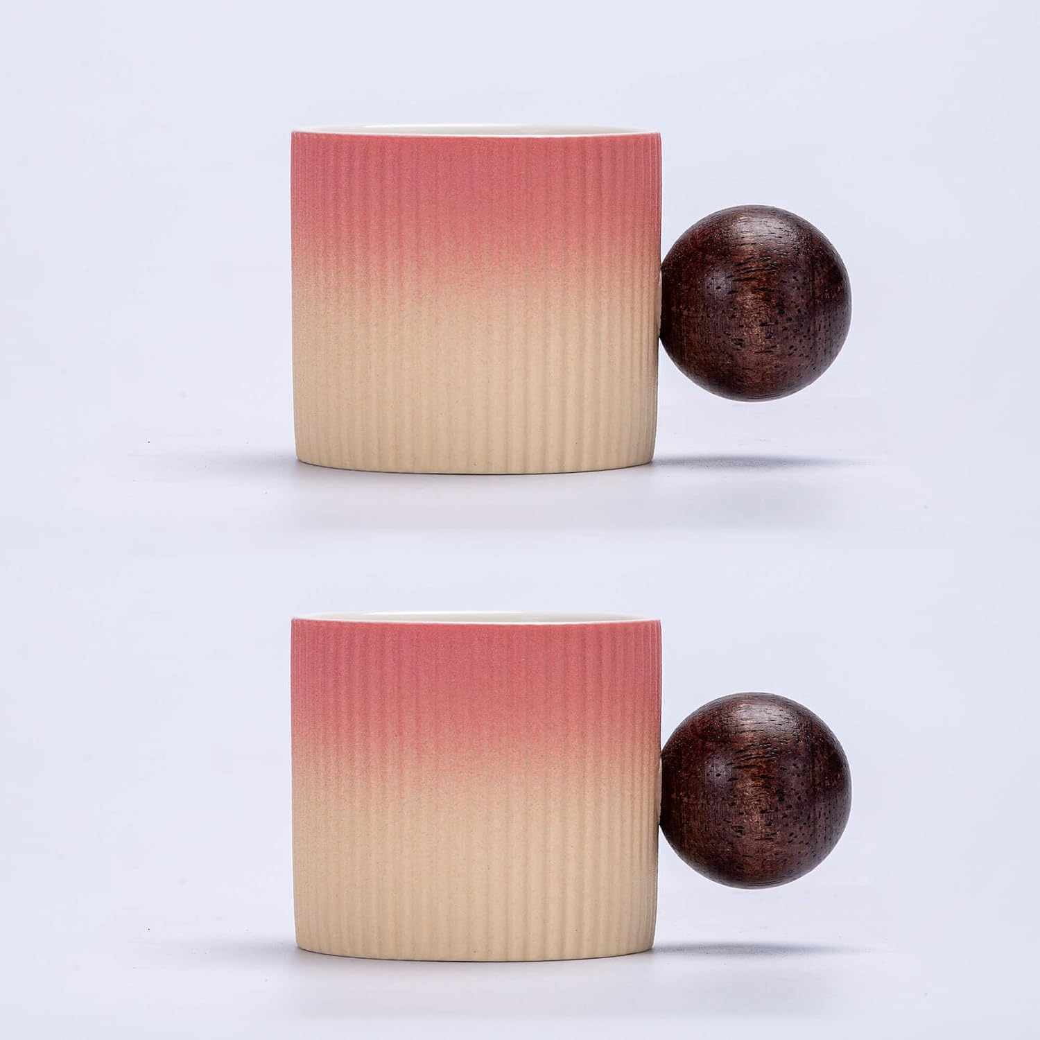 Two ribbed ceramic containers with a gradient color pattern and two wooden spheres on a light gray background.