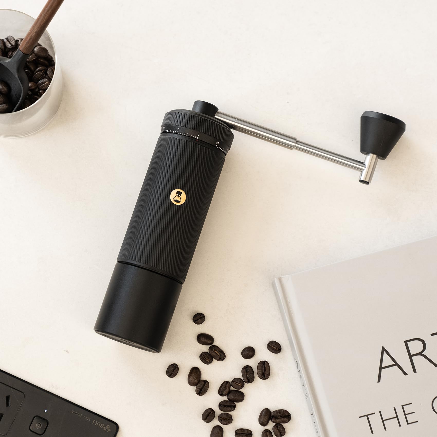 on a white surface with coffee beans and a notebook.